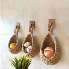 there are three baskets hanging on the wall