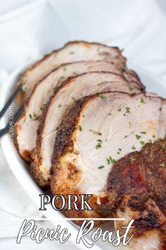 pork roast with parsley on top in a white bowl