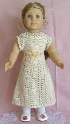 the doll is wearing a white dress and pink shoes