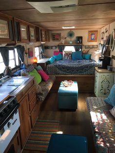 the inside of a small rv with couches, tables and other items in it