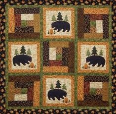 a black bear quilt with trees on it