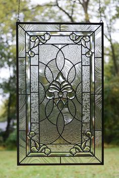 a stained glass window with an intricate design on it's side and leaves in the middle