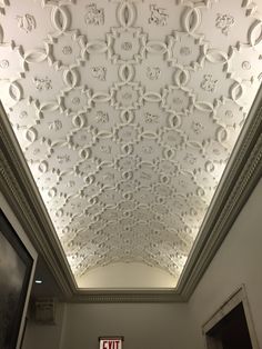 the ceiling in an office building is decorated with intricate designs and decorative plaster moldings