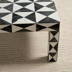 a black and white table sitting on top of a rug