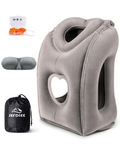 the inflatable travel pillow is next to an ear plugged device and bag