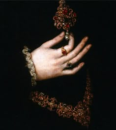 a close up of a person's hand with jewelry on it