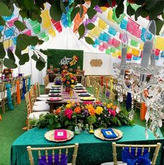 the tables are decorated with colorful flowers and place settings