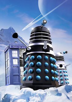 the tardishes are standing in the snow by the doctor who is next to them