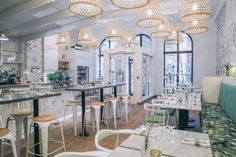 the interior of a restaurant with tables and chairs