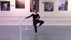 a woman standing on a rail in an art gallery