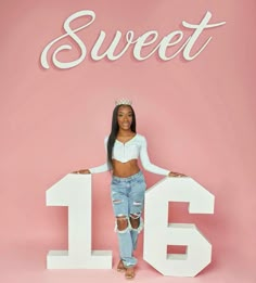 a woman standing in front of a sign that says sweet 16