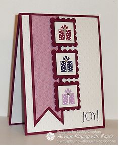 a close up of a greeting card with presents on it, and the words joy