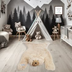 a child's bedroom with a teepee tent and teddy bears on the floor