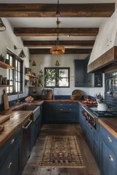 a kitchen with blue cabinets and wooden floors, an area rug on the floor that matches the ceiling