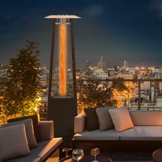 an outdoor lounge area overlooking the city at night