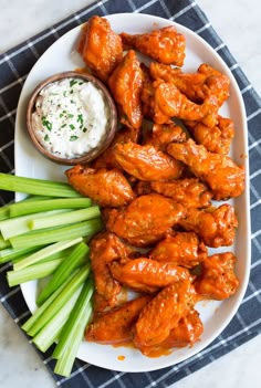 buffalo wings on a plate with celery and ranch dip