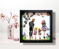 an image of three people with flowers in vases and paper cutouts on the wall