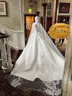 a white wedding dress on display in a room