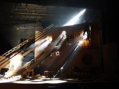 the stage lights are shining down on the people sitting in chairs at the bottom of the stairs