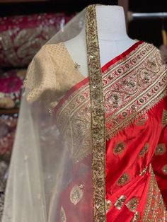 Bright Red Banarasi Silk Saree with an ensemble of fine work beads, pearls and sequins highlight intensifies the look of the Saree. Cut dana and zari work makes it a must way outfit for every bride to be. The saree has an unstitched blouse and a contrasting net dupatta is another great way to add it to your bridal wear. Fabric: Pure Silk Custom designed according to client measurements and color preference. Production and delivery time is 120 days! Elegant Chinon Lehenga For Traditional Ceremonies, Elegant Gold Choli For Traditional Ceremonies, Gold Kundan Anarkali Set For Traditional Ceremonies, Gold Chinon Lehenga For Traditional Ceremonies, Raw Silk Gold Choli For Traditional Ceremonies, Gold Chinon Sharara For Traditional Ceremonies, Elegant Red Chanderi Lehenga, Red Raw Silk Dupatta With Cutdana Details, Red Raw Silk Dupatta With Cutdana