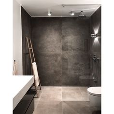 a bathroom with grey walls and tile flooring