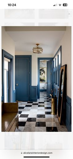 a hallway with blue doors and black and white checkered flooring on the walls