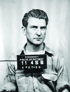 an old mug shot of a man in uniform with his name on the license plate