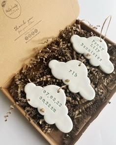 two white ceramic sheep ornaments in a gift box with the date and year printed on them