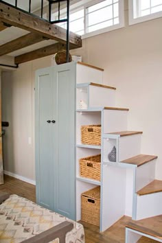 a room with some shelves and baskets on the floor next to a bed in it