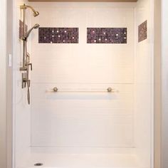 a bathroom with white walls and tiled flooring next to a walk in shower stall