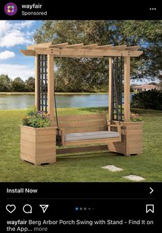 a wooden bench sitting on top of a lush green field