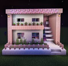 a small house with plants on the front and stairs leading up to it's second floor