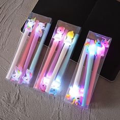 four different colored toothbrushes in their packaging