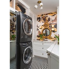 a washer and dryer in a laundry room with patterned flooring on the walls