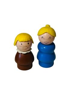 two small wooden dolls sitting next to each other