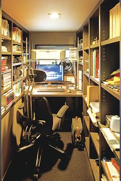 an office with lots of bookshelves and desks