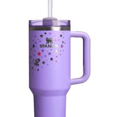 the tumbler cup is purple with stars on it and has a straw in it