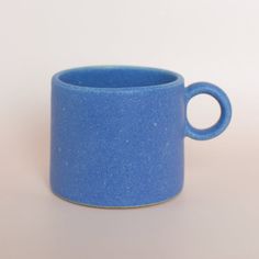 a blue cup sitting on top of a white table