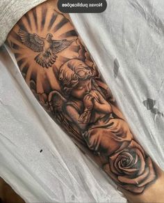 a man's arm with an angel and rose tattoo on it