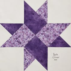 a purple and white quilted star pattern