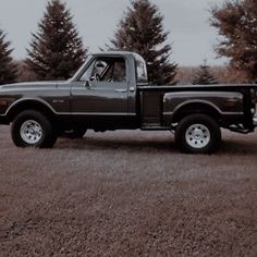 a black pickup truck parked in a field