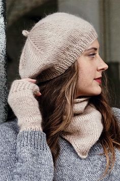 a woman wearing a knitted hat and scarf