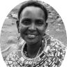 a black and white photo of a smiling woman with beads on her neck, in a circle