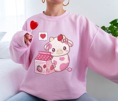 PLEASE NOTE: This is a UNISEX sweater. If you want an oversized look then consider ordering up a size. This cute strawberry cow sweater will look adorable on you! Makes for a great gift to give to your friends as well. The collar is ribbed knit, so it retains its shape even after washing. There are no itchy side seams on these sweaters. .: 50% cotton, 50% polyester .: Medium-heavy fabric (8.0 oz/yd² (271.25 g/m .: Loose fit .: Sewn-in label .: Runs true to size Milk Outfit, Gifts For Teenage Girls, Cow Outfits, Kawaii Strawberry, Kawaii Sweatshirt, Strawberry Cow, Sweatshirt Aesthetic, Crochet Cow, Cow Shirt