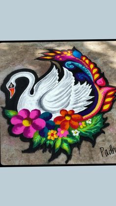 a white swan painted on the ground with flowers