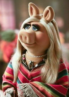 the miss piggy doll is wearing a red striped shirt