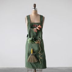 a mannequin wearing an apron with various items on it