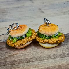 two miniature sandwiches are sitting on a wooden table