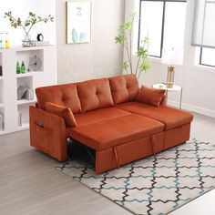 a living room with an orange couch and rug