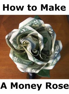 a paper rose made out of money sitting on top of a table